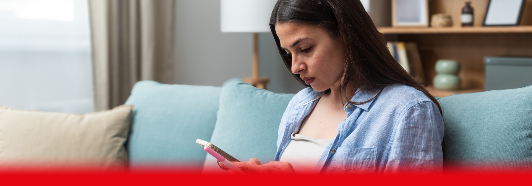 woman on phone and holding hcg test