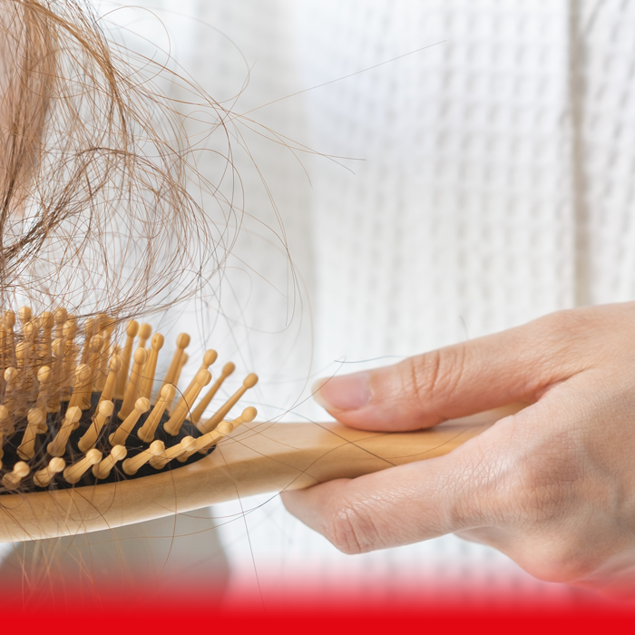 woman taking hair out of brush