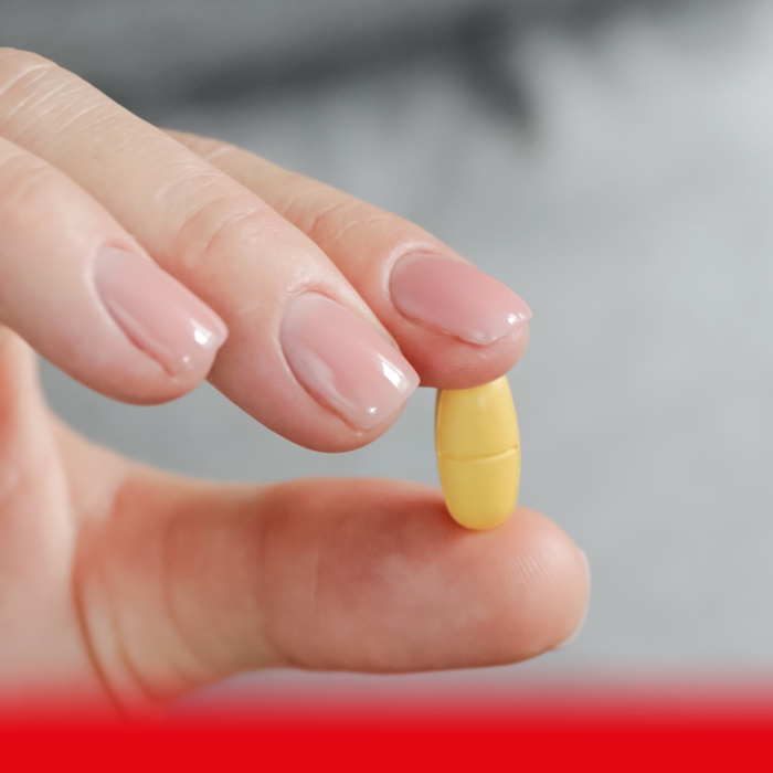 person holding vitamin supplement