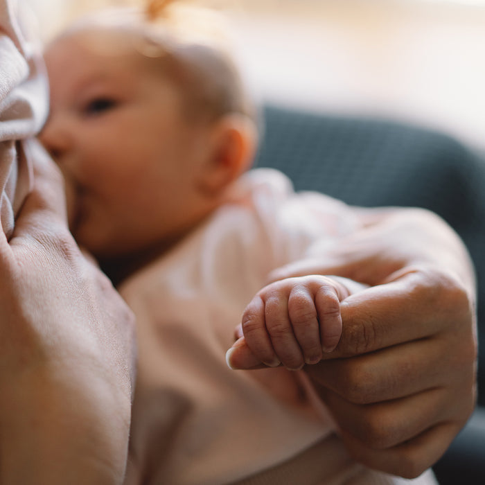 A woman breastfeeding a newborn baby