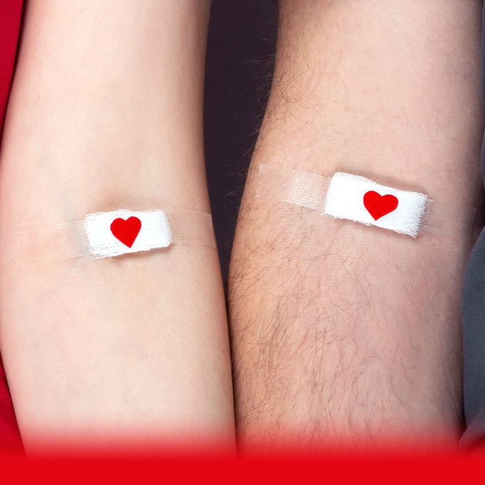 man and woman with plasters on after a blood test