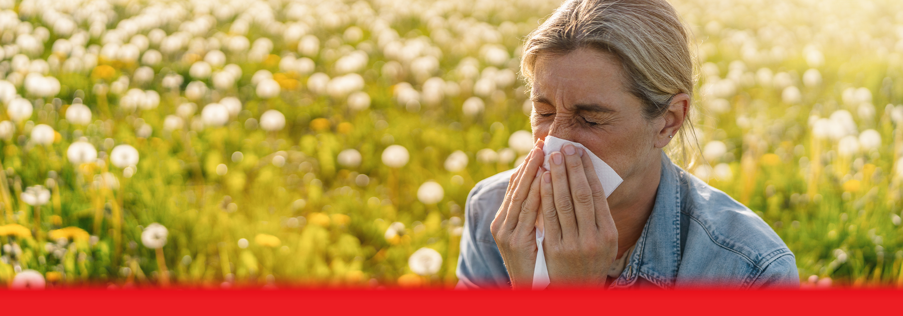 lady sneezing in field 