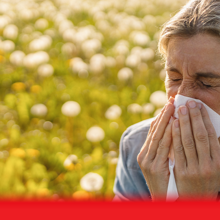 lady sneezing in field 