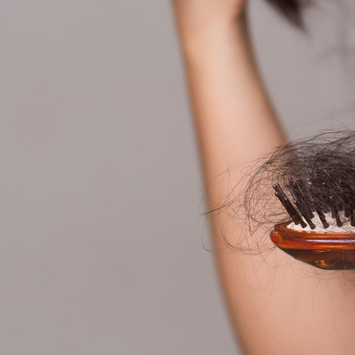 Woman inspecting her scalp