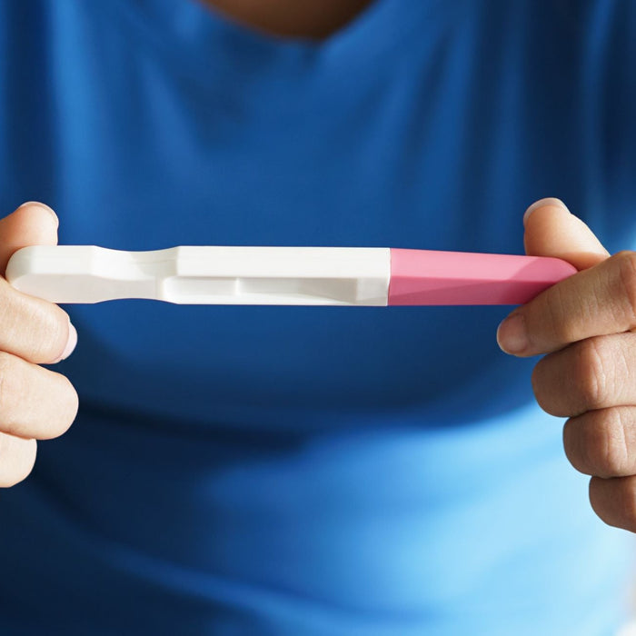 Woman holding pregnancy test