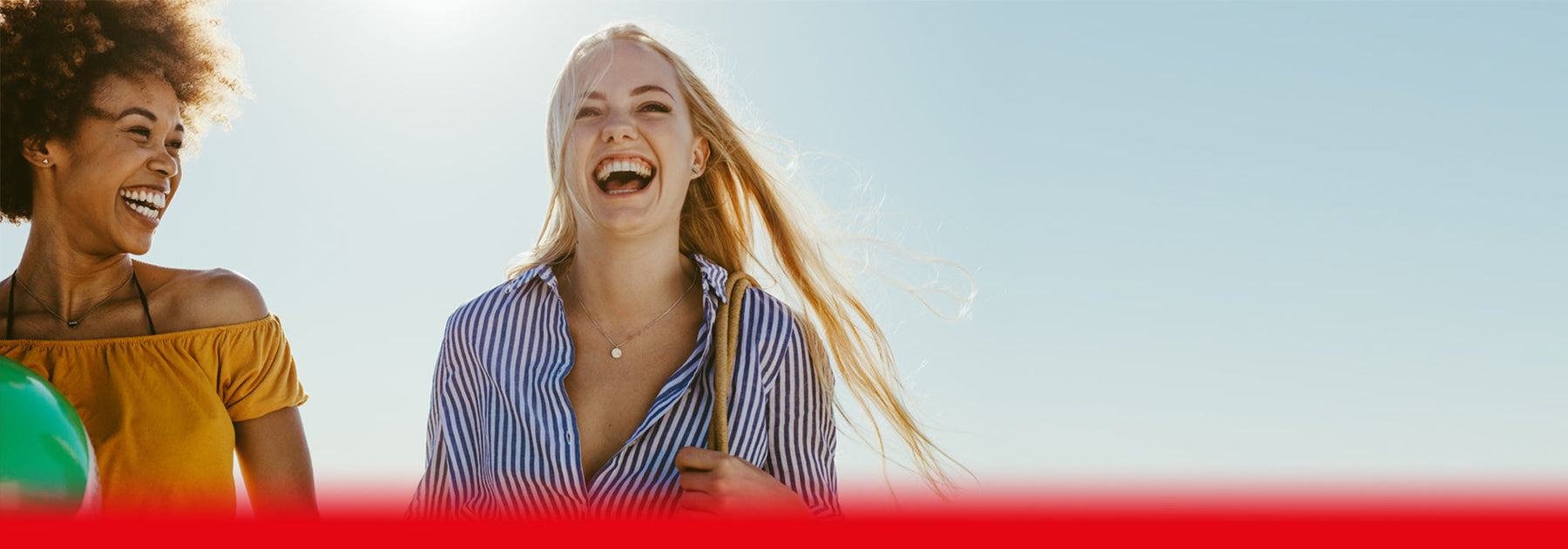 Two women smiling on the beach