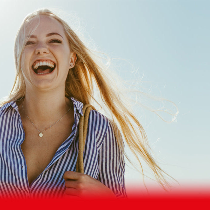 Two women smiling on the beach